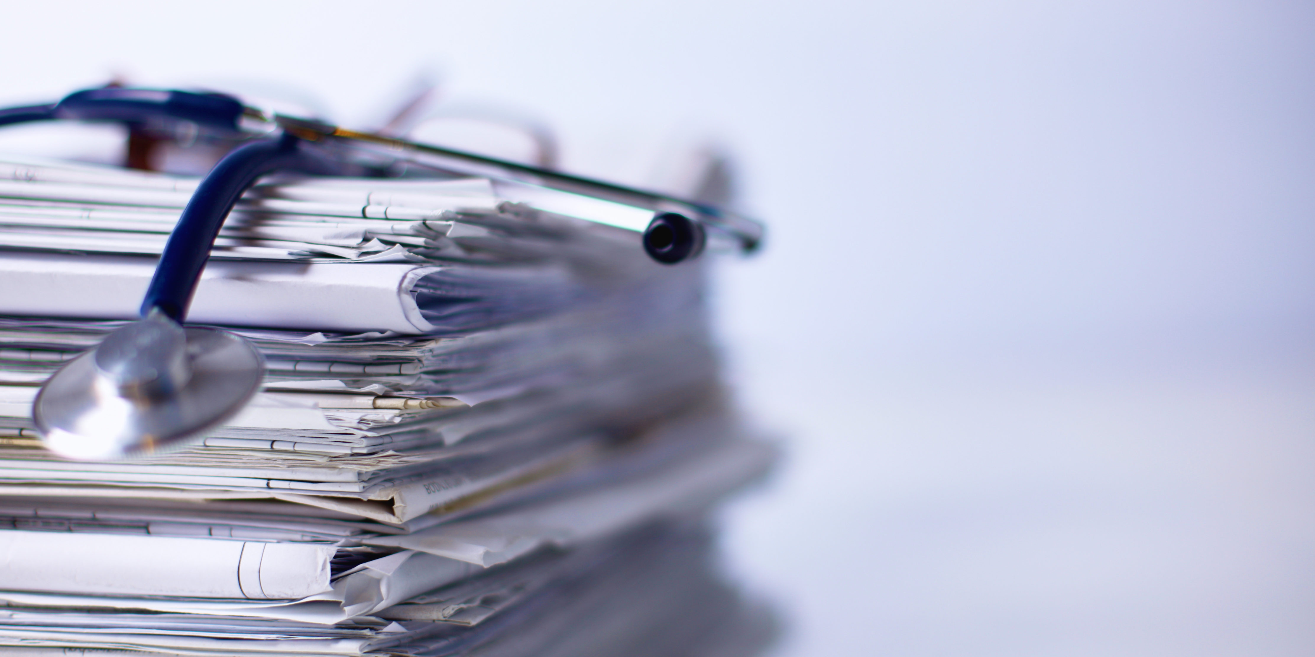 Medical stethoscope on the stack of paper