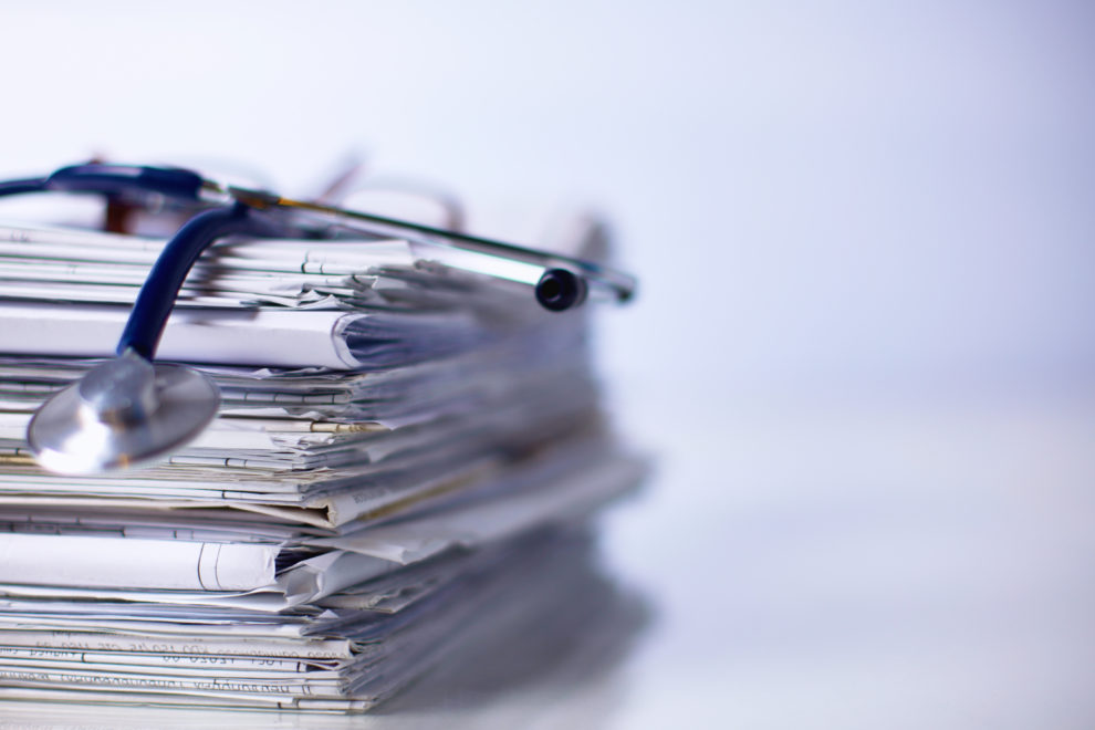 Medical stethoscope on the stack of paper